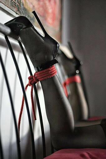 slave feet tied to headboard wearing heels