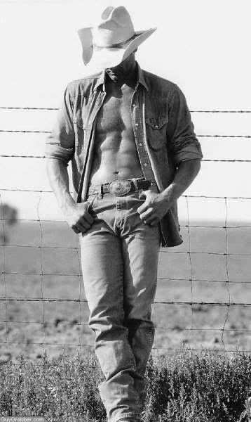 cowboy leaning against fence with open shirt