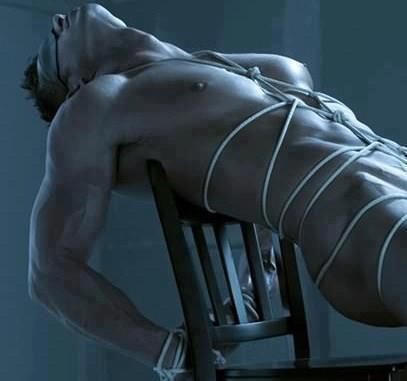 naked male slave tied to a chair